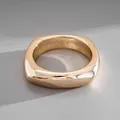 Detailed close-up of a chunky polished gold-tone square ring with a smooth finish - Gold Geometric Square Style