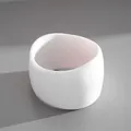 Detailed view of a white chunky resin geometric bangle on a textured gray background - Simple White Style