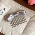 Detailed view of an elegant silver satin bow hair comb featuring a premium metal insert design - Hair Stick / Silver Gray