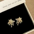Exquisite gold star stud earrings featuring cascading rhinestones in a premium box - Gold
