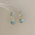 Detail showing 18k gold plated hoop earrings with vibrant blue pavé zircon beads. - Hoop Hollow Ball Style (Gold) / Blue