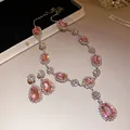 Elegant jewelry set with pink teardrop gemstones and silver-toned necklace and earrings - Pink