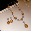 Detail of luxury orange teardrop gemstone jewelry set with sparkling rhinestones - Brown