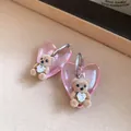 Detailed close-up of pink heart earrings with cute brown flocked teddy bear and crystal - Pink-Coffee
