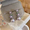 Close-up of French luxury flower drop earrings with purple zircon and lavender pearls. - Silver