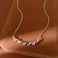 Detailed view of silver necklace with colorful stones in twisted zircon setting - Colored Zirconia Twisted Pendant Necklace / Silver - Rainbow