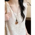 Vintage resin amber pendant necklace with adjustable leather cord for an elegant ethnic style. - Irregular Oval Style (HN12383-1) / Brown