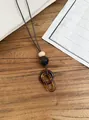Vintage ethnic style resin acrylic oval pendant necklace on a natural leather cord - Double Buckle Amber Style (HN12382-1) / Brown