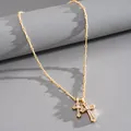 High-detail view of golden double layered cross pendant necklace with zircon stones - Gold