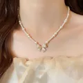 Elegant French style pearl necklace with a sparkling cubic zirconia bow pendant charm. - Gold-Pink