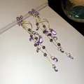 Detail view of purple butterfly crystal earrings with long teardrop tassel beads - Butterfly Tassel Style / Purple