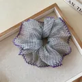 Close-up of a blue chiffon scrunchie with purple polka dots and lace edges on a wooden tray - Green Blue Polka Dot