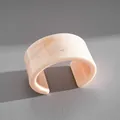 Close-up view showing the natural marbled texture of this light pink resin cuff bangle - Large Geometric Open Bangle / Large / Off White