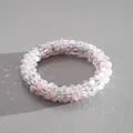 Close-up of pastel pink and blue crystal faceted beads on a magnetic jewelry piece - Bracelet / Pink-Gray