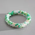 Close-up detail of fresh multi-colored faceted crystal beads on a magnetic jewelry piece. - Bracelet / White-Green