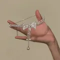 Exquisite close-up of a sparkling rhinestone bow choker with dangling pearl accents - Silver Bowknot (HN11917) / Silver