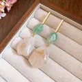 Elegant geometric resin earrings with green and cream marble pendants on gold bars. - Green-White