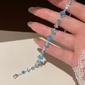 Detailed macro view of a silver bracelet featuring vibrant blue geometric zircon stones. - Cold Aesthetic Water Drop Style (HB5985-1) / Silver Blue