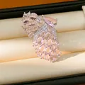 Macro detail view of an elegant butterfly wing open ring featuring light pink zircon stones - Open Butterfly Wings / Silver-Pink