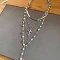Detail of multi-layer silver necklace featuring pearls and a rhinestone cross pendant - Silver