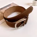 Detailed view of a brown leather belt featuring white zigzag stitching and silver buckle - Pin Buckle Style / Coffee