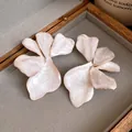 Detailed view of French retro pearlescent flower stud earrings with golden edges - French Flower Style (HE33367) / White