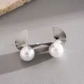 Detailed view of silver-toned geometric fan stud earrings with large white pearls - Fan-Shaped Geometric Pearl Style / Silver