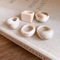 Detailed view of five vintage resin rings with brown marbled texture on linen book - 5 Pieces / Beige Smudge