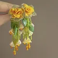 Close-up of handmade yellow chiffon flower earrings with long green bead tassels. - Chiffon Rose Tassel (2#)