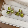 Detailed macro view of elegant green floral stud earrings with textured metallic petals - Three-Petal Flower Metallic Paint (38#)