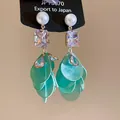 Close-up detail of elegant green floral tassel earrings with pearl and crystal accents. - Artificial Pearl Rectangular Crystal Flower (40#)