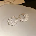 Detailed view of 18k gold plated hoop earrings with shimmering pearls and zircons - Silver