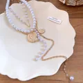Detail of gold conch shell and pearl layered necklace for beach vacation outfits - Necklace / Gold with White