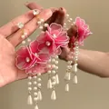 Detailed view of pink mesh flower earrings with pearl tassels and zircon accents - Silver Earring Post - Pink