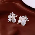 Detailed macro of crystal flower earrings with shell petals and pearl drops - Silver Earring Post Style / White