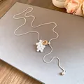 Elegant snake chain necklace featuring pearl teardrops and a stone accent on a grey surface. - Yellow Stone Style / Silver