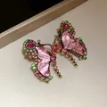 Close-up of a vintage butterfly jewelry piece with pink resin and colorful rhinestones. - Earrings / 925 Silver Needle / Gold Base with Rose Red and Green