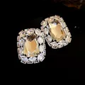 Close-up of elegant silver stud earrings featuring large rectangular shimmering clear stones - Square Rhinestone Style (HE31997) / Silver