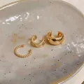 Elegant gold-plated non-piercing ear cuff set for women presented on ceramic plate - Three-Piece Set / Gold