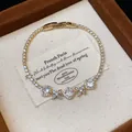 Detailed view of a cubic zirconia flower bracelet with an elegant gold-tone finish - Gold-White