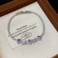 Close-up of French style zircon bracelet with purple square stones and flower accents. - Silver-Purple