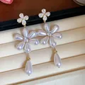 Close-up of elegant floral drop earrings with pearls and zircon stones in a jewelry box - Silver Earring Post-White / White