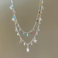 Close-up view of a double-layered necklace featuring colorful rhinestones and sea charms. - Double Layer Necklace / Silver Multicolor