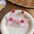 Detailed close-up view of bohemian mesh flower earrings with magenta rose accents - Simulated 3D Flower Style / Pink