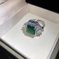 Macro view of an elegant silver open ring featuring a square green zircon stone - Silver-Green