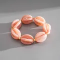 Pfirsich marmoriertes Acryl-Armband, elastisch, klobig, mit goldenen Perlen - Rosa