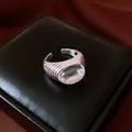 Macro view of vintage silver ribbed ring with clear resin cabochon on a black jewelry box - Geometric Open Style (HR3621) / Silver