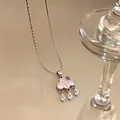 Detailed macro shot of a pink cloud pendant necklace featuring three clear water drop zircons - Cross Chain Style (HN11632)
