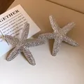 Close-up of textured silver starfish stud earrings with a stylish wrinkled surface. - Starfish Style (HE32782) / Silver