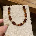 Close-up of vintage Maillard style acrylic barrel beads and gold accents necklace - Dark Coffee